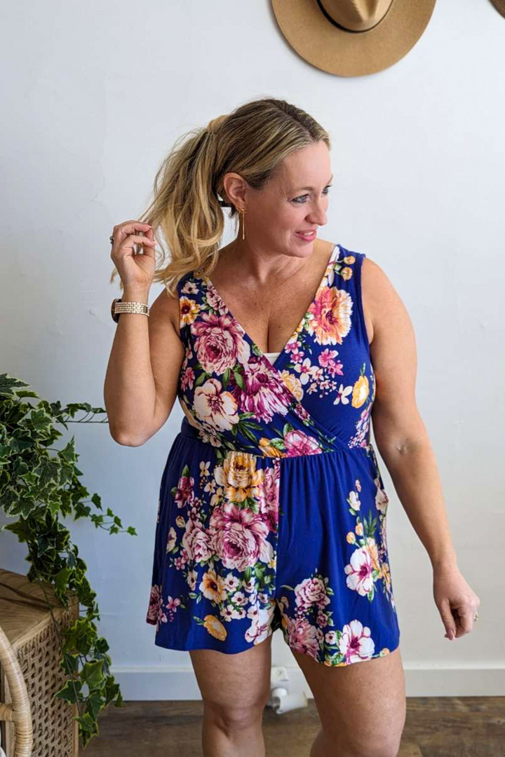 Beautiful Bright Vibrant Blue Floral Romper with short sleeves, v-neck front and v-neck back, soft stretchy fabric perfect for Summer/Spring and vacations.