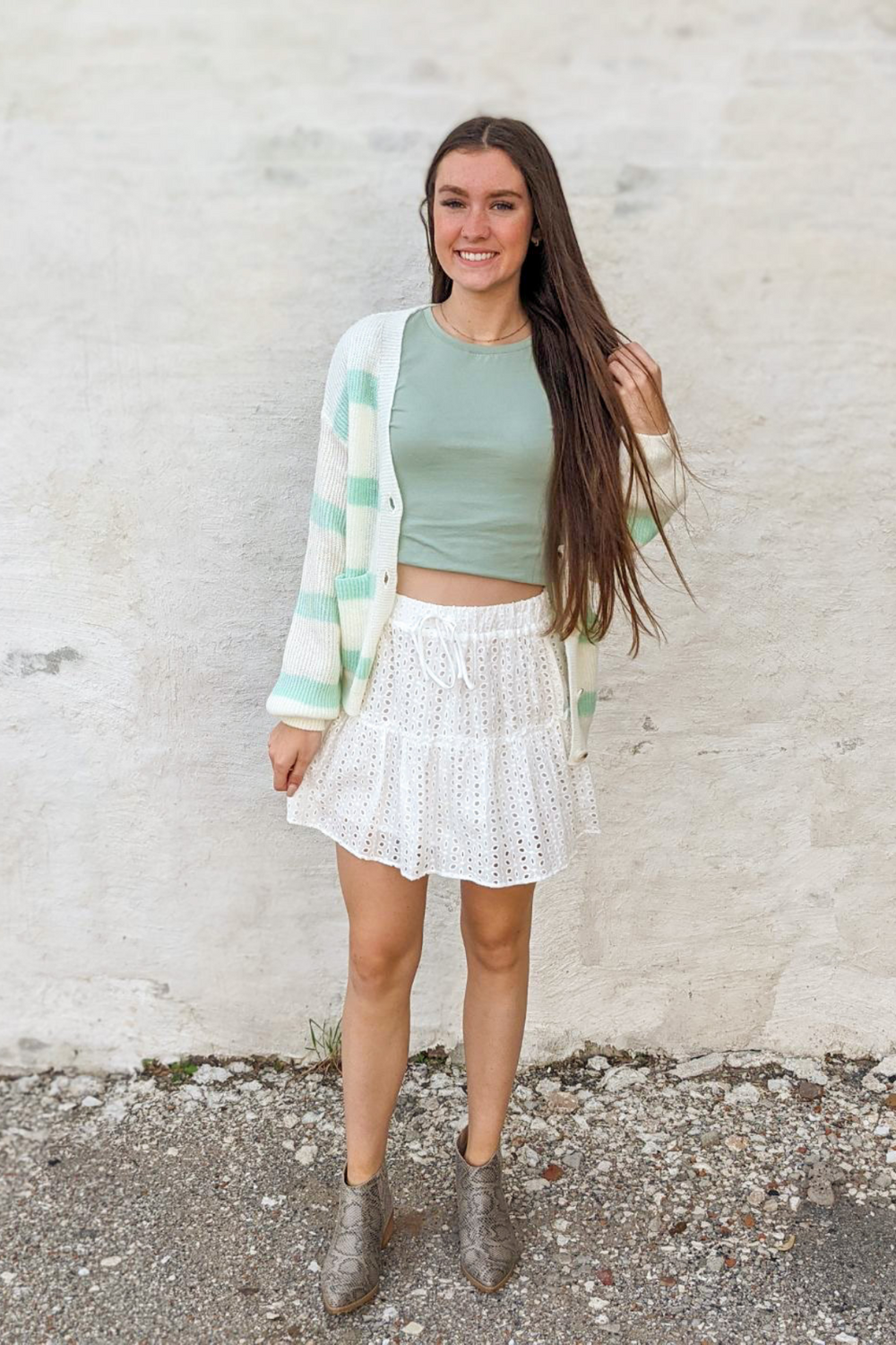 White Eyelet, Lace, ruffle Detail with decorative tie featuring an elastic waist mini skirt. 