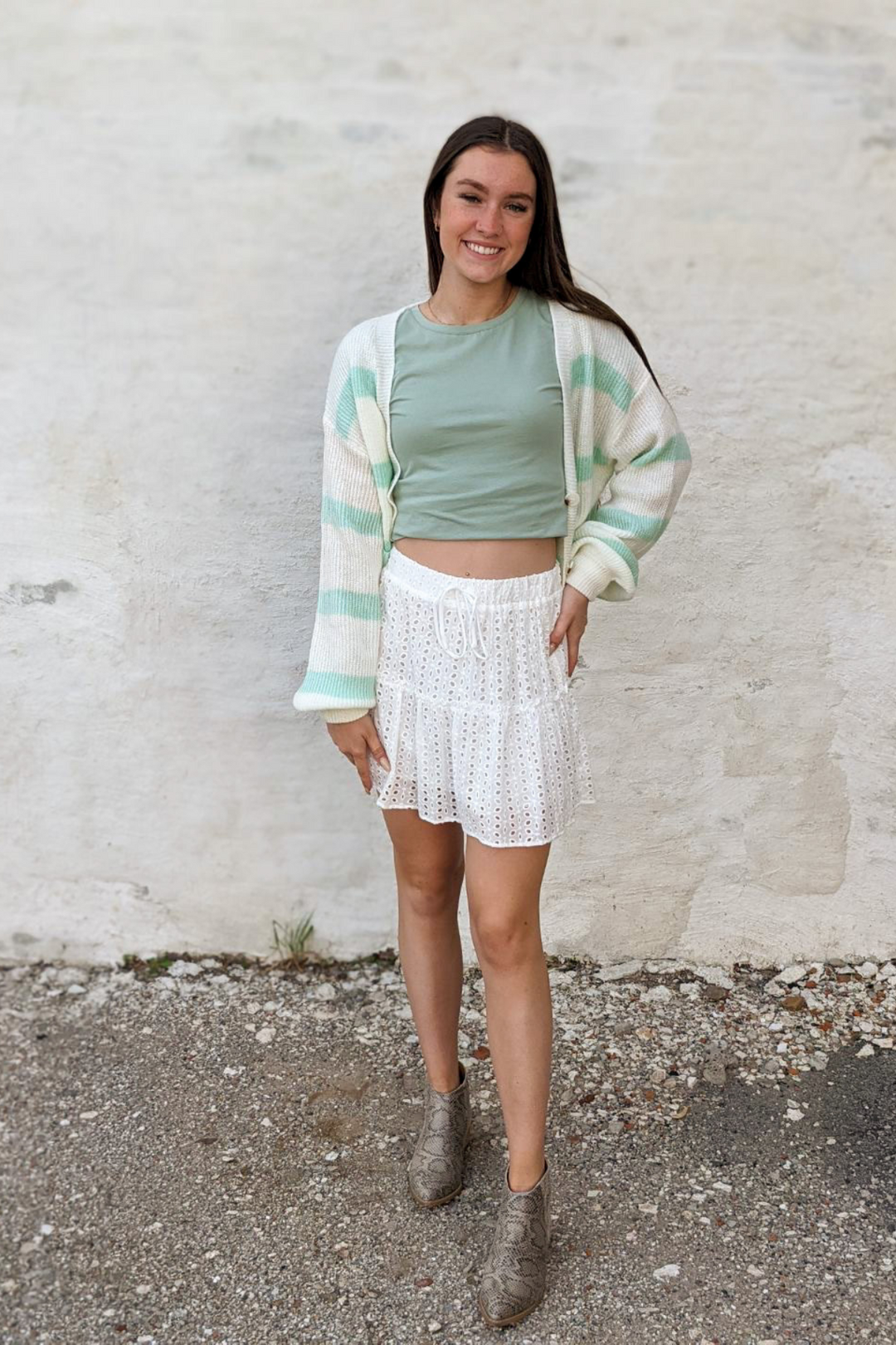 White Eyelet, Lace, ruffle Detail with decorative tie featuring an elastic waist mini skirt. 