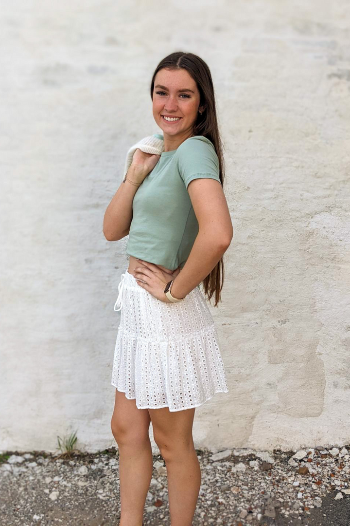 White Eyelet, Lace, ruffle Detail with decorative tie featuring an elastic waist mini skirt. 